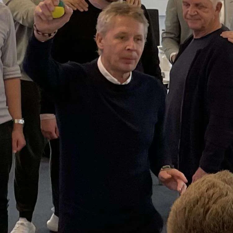A coach working with a group during a teaming exercise