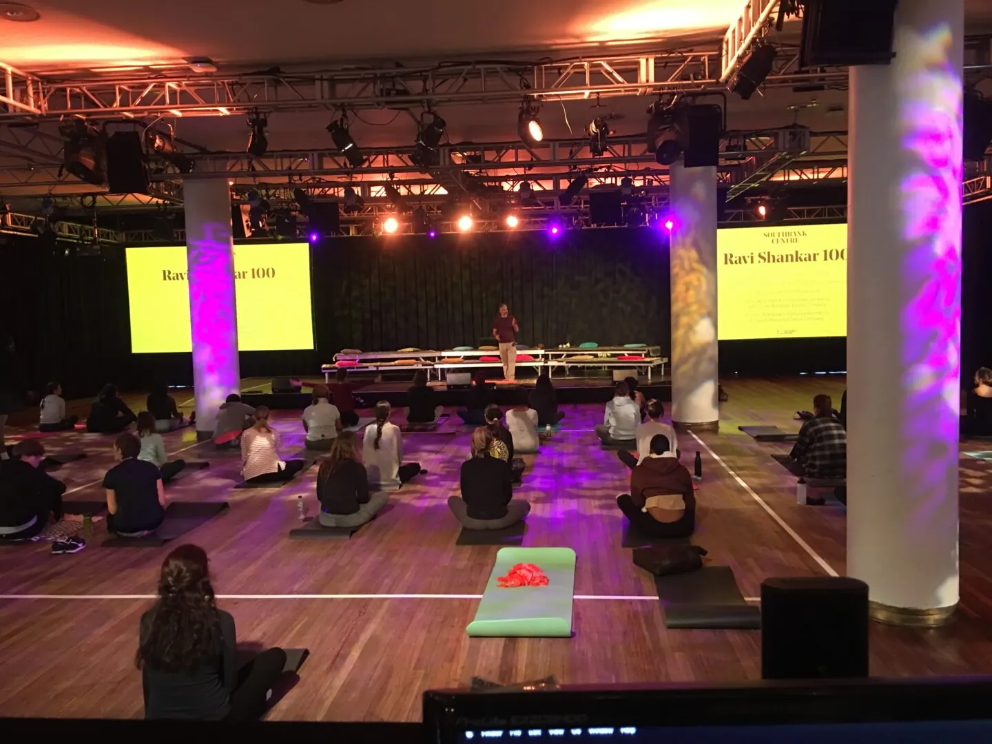 An event hall set with mats under stage lights for a reset session