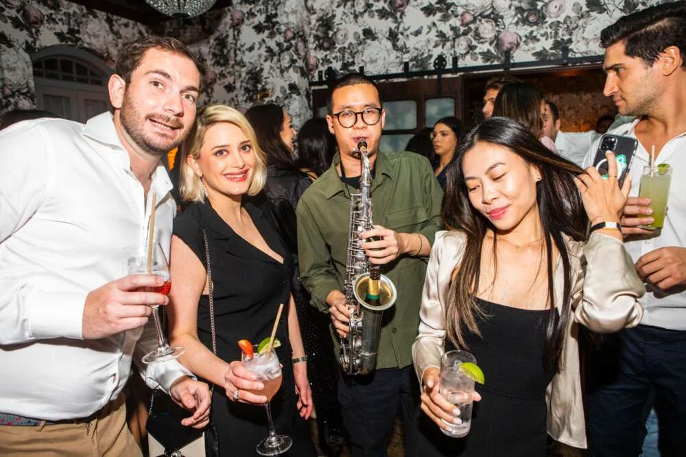 A saxophonist performing at an evening event