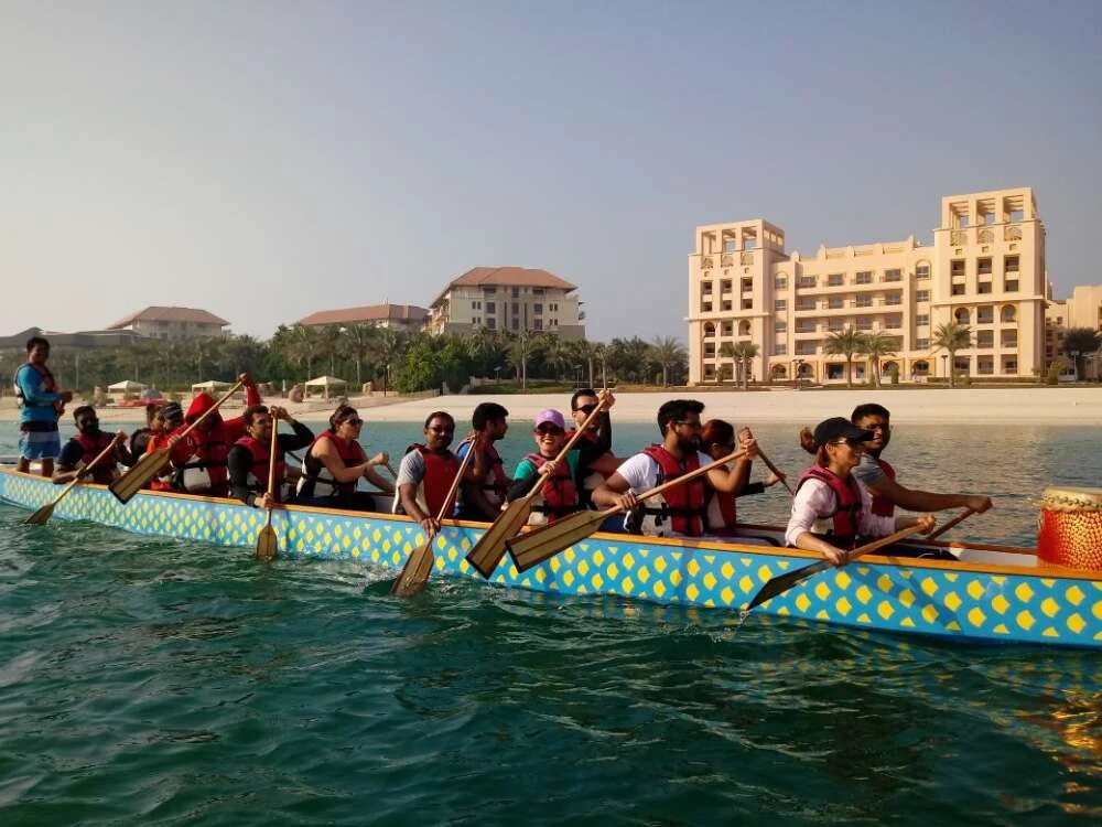 A team paddling a dragon boat off the coast of Dubai