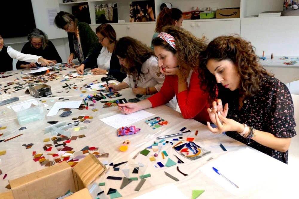 Guests assembling pieces of a stained-glass window together