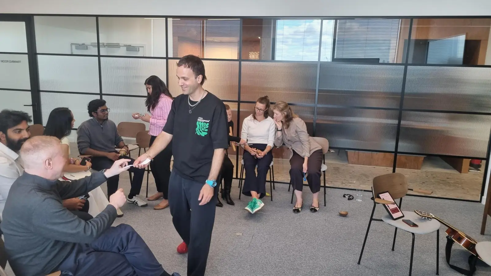 Colleagues working in pairs during a listening lab in an office
