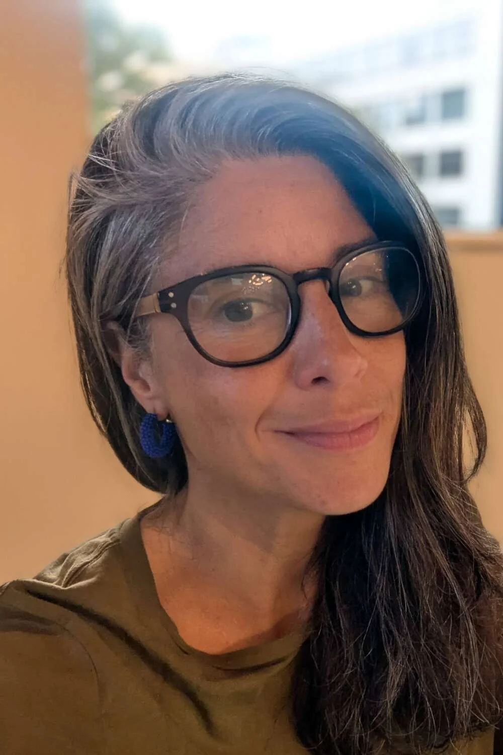 Portrait of a smiling facilitator in glasses