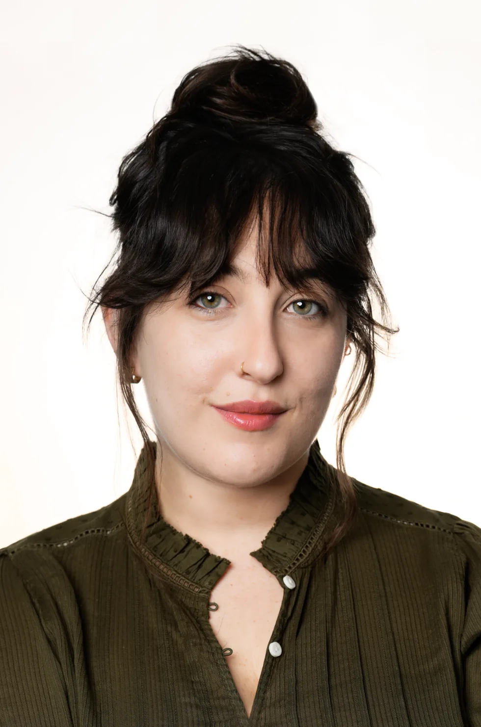 Juli smiling in a studio portrait, her hair up